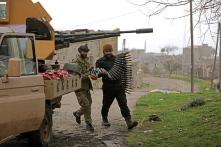 Turkish-backed Free Syrian Army fighters hold an ammunition belt near the city of Afrin, Syria February 21, 2018. REUTERS/Khalil Ashawi