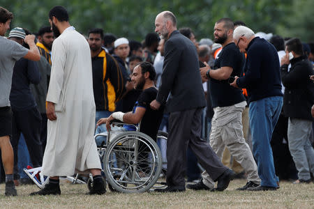 People attend the burial ceremony for the victims of the mosque attacks at the Memorial Park Cemetery in Christchurch, New Zealand March 20, 2019. REUTERS/Jorge Silva