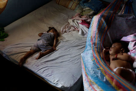 Sisters of Eliannys Vivas, who died from diphtheria, sleep in a room at their home in Pariaguan, Venezuela January 26, 2017. REUTERS/Marco Bello