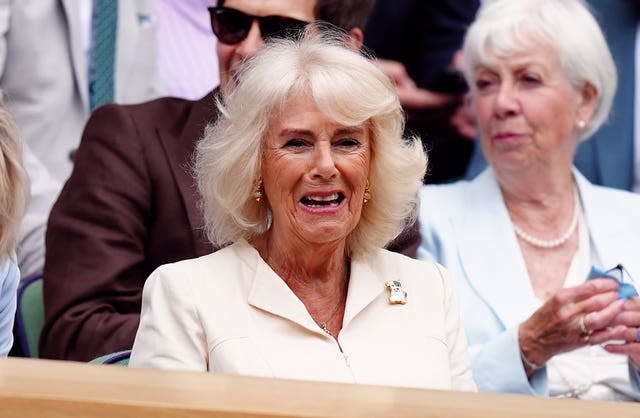 Camilla smiles as she sits in the royal box at Wimbledon