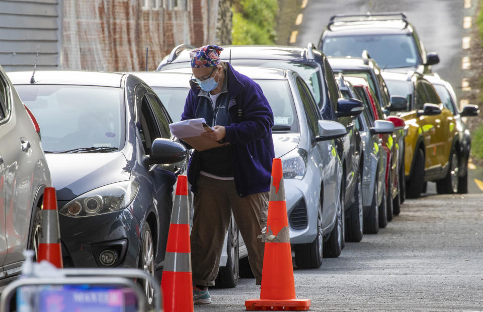 Medical staff test people in their car at a COVID-19 testing station in Wellington, New Zealand, Thursday, June 24, 2021. After enjoying nearly four months without any community transmission of the coronavirus, New Zealanders were on edge Wednesday after health authorities said an infectious traveler from Australia had visited over the weekend. (Mark Mitchell/NZ Herald via AP)