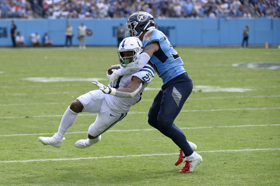 Indianapolis Colts running back Nyheim Hines (21) is stopped by Tennessee Titans safety Amani Hooker during the second half of an NFL football game Sunday, Oct. 23, 2022, in Nashville, Tenn. (AP Photo/Mark Zaleski)