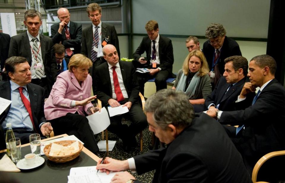 The then German chancellor Angela Merkel, centre, with the then European Commission president Jose Manuel Barroso, left, and other world leaders at the final night of Cop15 in December 2009 in Copenhagen