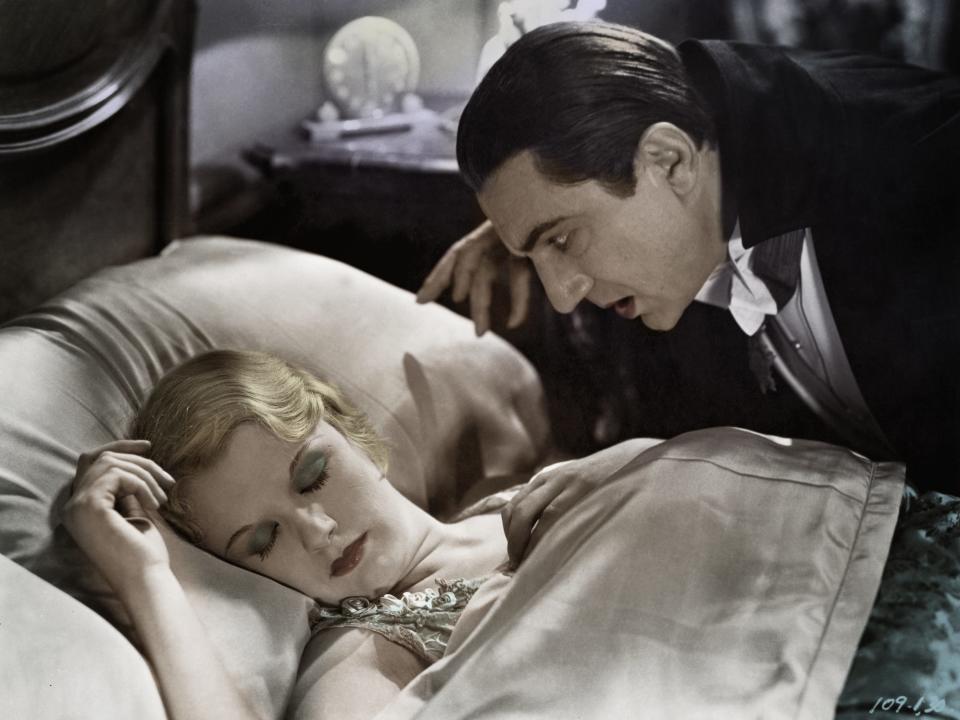 Bela Lugosi as Dracula looms over a sleeping Helen Chandler in the movie Dracula