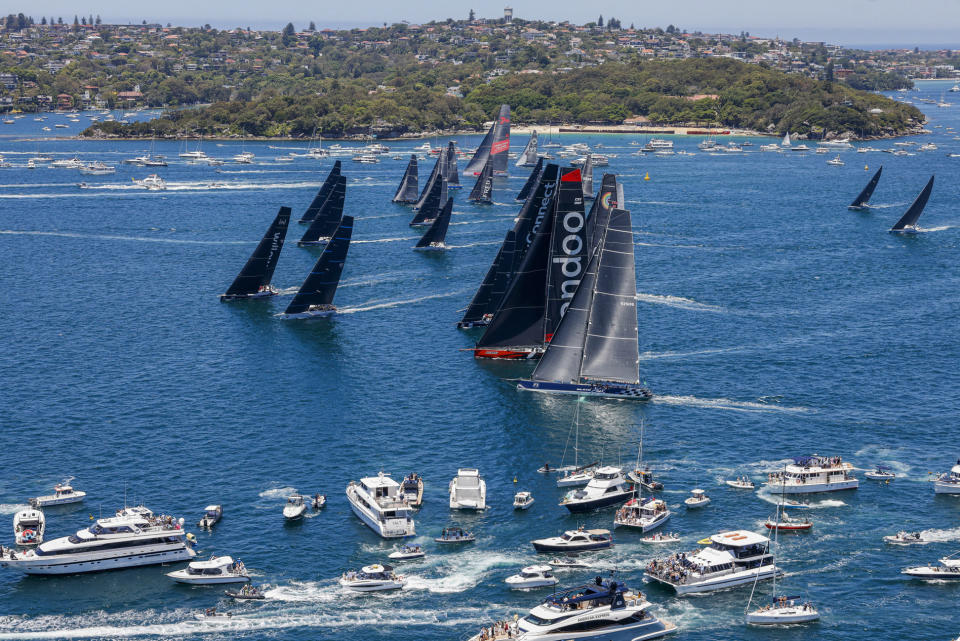 In this photo provided by ROLEX, boats race to the heads at the the start of the Sydney Hobart yacht race on Sydney Harbour, Australia, Monday, Dec. 26, 2022. (Carlo Borlenghi/ROLEX via AP)