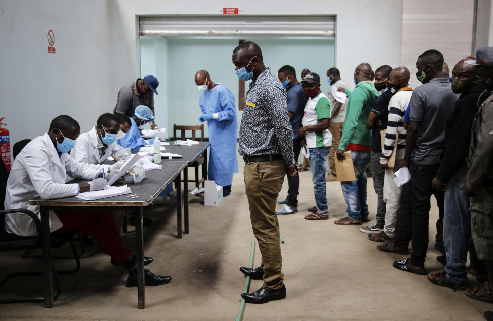 FILE - In this June 1, 2020, file photo, truck drivers entering Kenya queue to be tested for the coronavirus on the Kenya side of the Namanga border crossing with Tanzania. Tanzania's President John Magufuli openly expressed doubt about COVID-19 vaccines and accused people who were vaccinated outside the East African nation of bringing new infections into the country. (AP Photo/Brian Inganga, File)