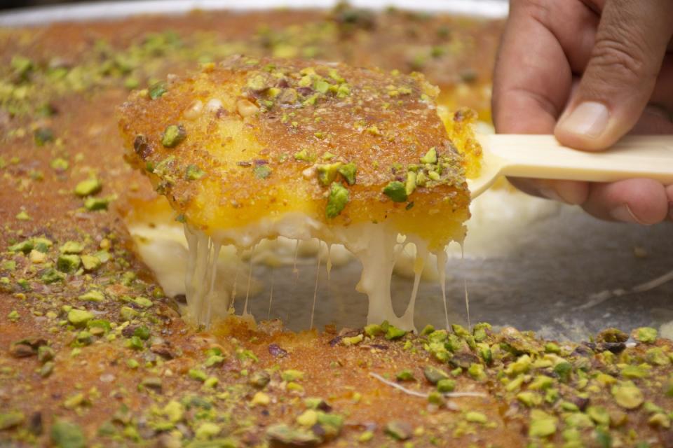 eid al fitr food arabic sweet konafa or knafeh with white cheese and pistachio