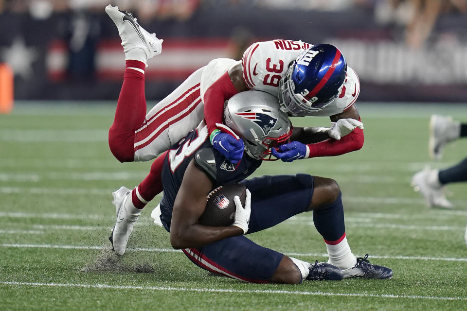 New York Giants safety Trenton Thompson (39) brings down New England Patriots wide receiver Lil'Jordan Humphrey (83) during the second half of a preseason NFL football game Thursday, Aug. 11, 2022, in Foxborough, Mass. (AP Photo/Charles Krupa)