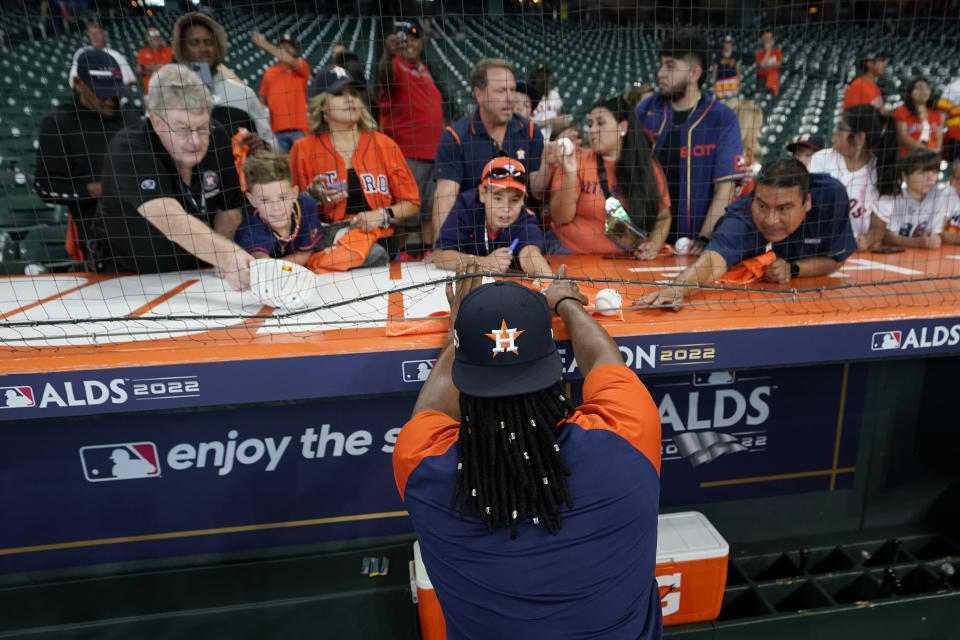 Houston Astros pitcher Framber Valdez signs autographs before Game 1 of an American League Division Series baseball game against the Seattle Mariners in Houston, Tuesday, Oct. 11, 2022. Valdez and teammate Luis Garcia got hair extensions this season and will show off their unique locks this postseason as Houston tries to reach the World Series for the fourth time in six years. (AP Photo/David J. Phillip)
