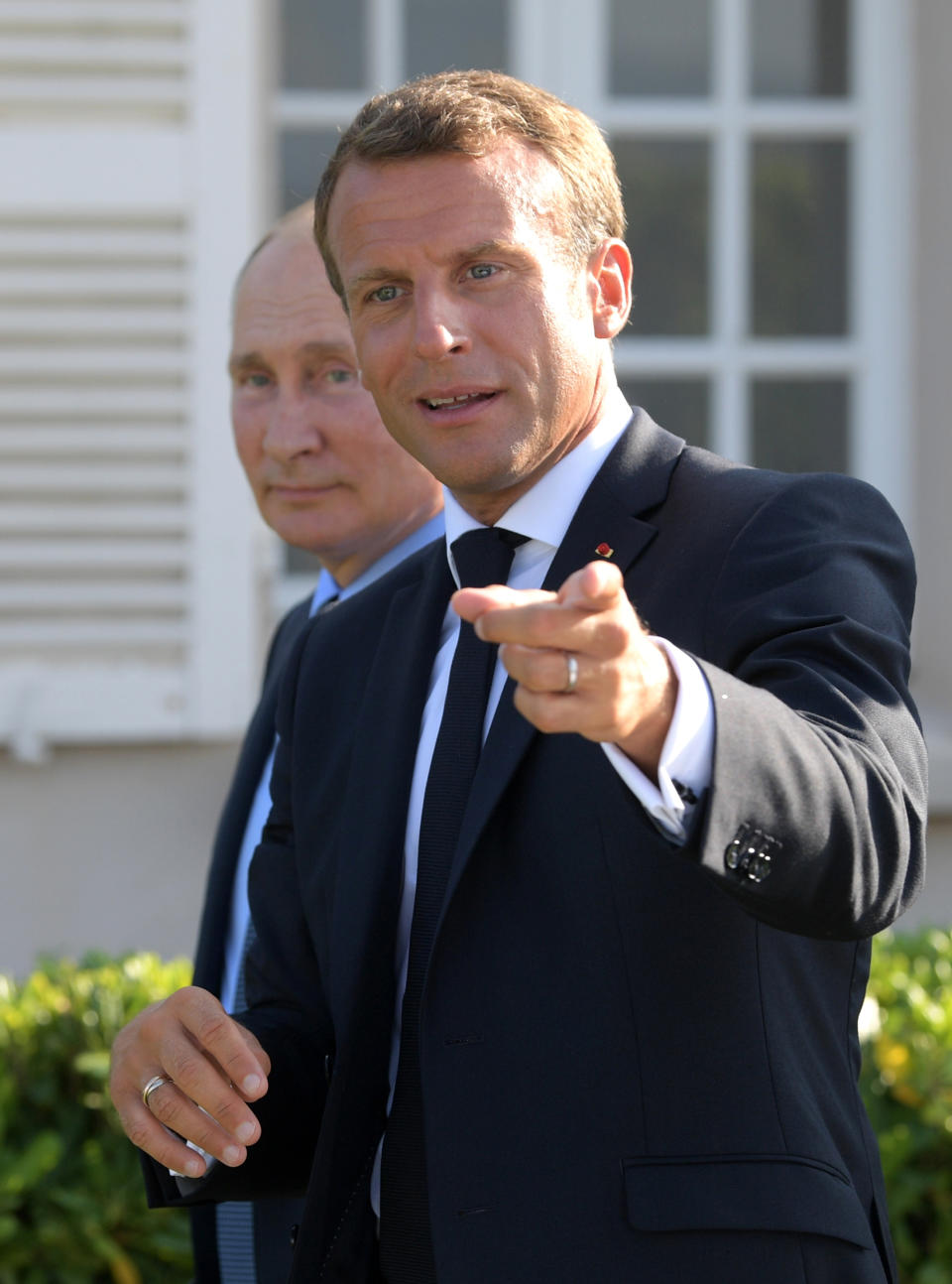 French President Emmanuel Macron, right, gestures with Russian President Vladimir Putin ahead of their meeting at the fort of Bregancon in Bormes-les-Mimosas, southern France, Monday Aug. 19, 2019. French President Emmanuel Macron and Russian President Vladimir Putin are meeting to discuss the world's major crises, including Ukraine, Iran and Syria, and try to improve Moscow's relations with the European Union. (Alexei Druzhinin, Sputnik, Kremlin Pool Photo via AP)