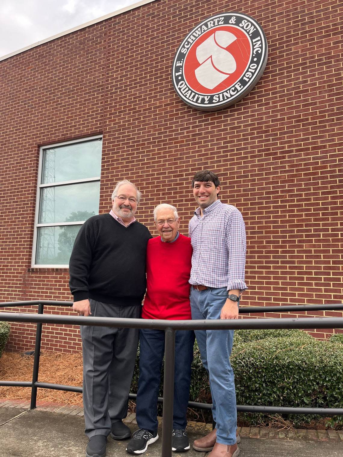 (From left) Steve Kruger, Melvin Kruger, and Michael Kruger smile for a photo in front of their family business L.E. Schwartz. The business has been a Macon staple since 1910.