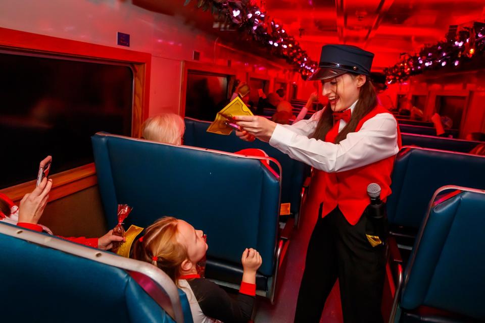 Performers dressed as stewards entertain passengers on Oklahoma City's "The Polar Express Train Ride," produced by Rail Events Productions, Thursday, Nov. 10, 2022. Based on the beloved book and movie, the rides continue through Dec. 27 at the Oklahoma Railway Museum in Oklahoma City.