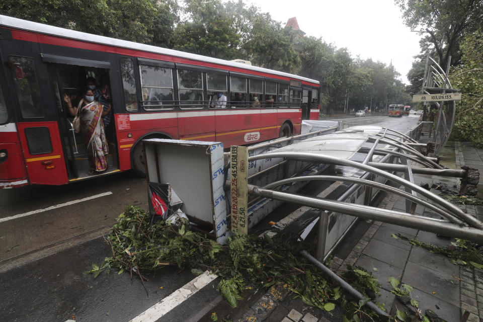 <strong>A bus drives past a damaged bus stand in Mumbai.</strong> (AP Photo/Rafiq Maqbool)