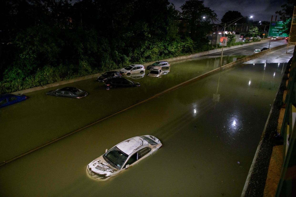 Floodwater surrounds vehicles following heavy rain on an expressway in Brooklyn, New York early on September 2.