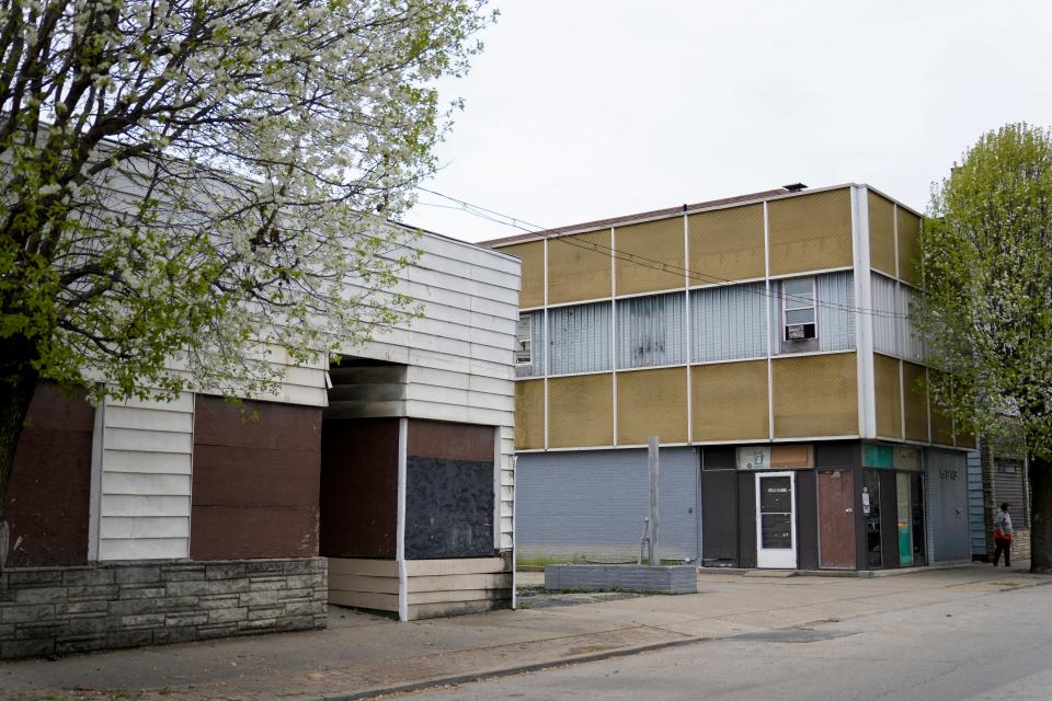 In Elmwood Place in the mid-1900s, "there wasn't an empty storefront on Vine Street," a 2020 report about the community said. Today, the main drag through town is punctuated by vacant buildings.