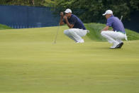 Tiger Woods, of the United States, left and Justin Thomas, of the United States, line up their putts on the third green during the first round of the US Open Golf Championship, Thursday, Sept. 17, 2020, in Mamaroneck, N.Y. (AP Photo/John Minchillo)