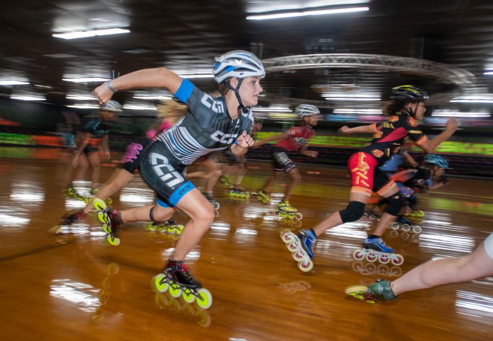 At left, Kayla Herring, 15, and others speed around the floor as the Emerald Coast Speed Team practices at Weber's Skate World in Milton on Aug. 11.