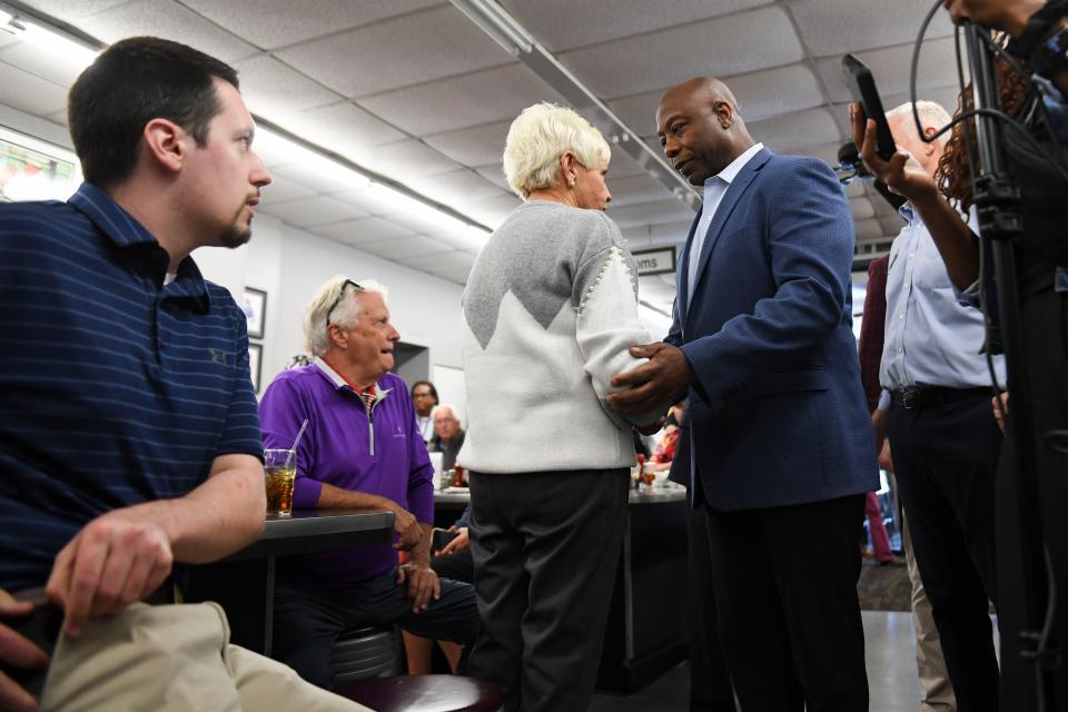 Tim Scott mingles with restaurant patrons at Stax's Original Restaurant on Poinsette Highway during a retail campaign event in Greenville, S.C., on Monday, Oct. 9, 2023.