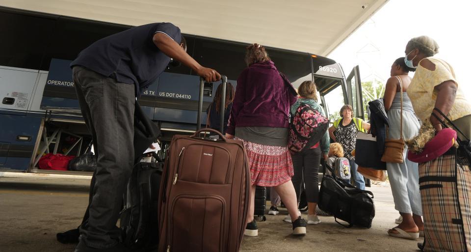 Jul 6, 2023; Columbus, Ohio, United States;  A staff member waits for people to board a Greyhound bus at the new bus station serving Greyhound, Barons, and other bus lines at 845 N. Wilson Road on the West Side. After years of being downtown, the bus station has moved to this location, but critics are venting about crime, nuisance and traffic of the new bus depot. They also say it's just too close to their residential homes. Mandatory Credit: Doral Chenoweth-The Columbus Dispatch