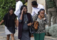 Civilians flee the scene at a hotel complex in Nairobi, Kenya Tuesday, Jan. 15, 2019. Terrorists attacked an upscale hotel complex in Kenya's capital Tuesday, sending people fleeing in panic as explosions and heavy gunfire reverberated through the neighborhood. (AP Photo/Ben Curtis)