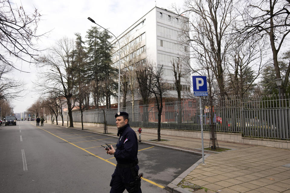 Serbian police officers guard the Russian embassy building during a rally to mark the one-year anniversary of Russia's invasion of Ukraine in Belgrade, Serbia, Friday, Feb. 24, 2023. A traditional Slavic ally, Serbia has maintained friendly relations with Russia despite the invasion and has refused to join Western sanctions designed to punish Moscow for the aggression. (AP Photo/Darko Vojinovic)