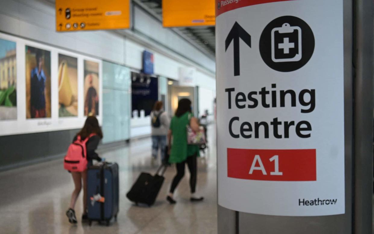 Passengers push their luggage past signage displaying the way to a Covid-19 test centre, in Terminal 5 at Heathrow airport in London, on June 3, 2021. - Health Secretary Matt Hancock has said it remains "too early" to say whether all coronavirus restrictions can end on June 21. Speaking ahead of a G7 health ministers' meeting, he told reporters: "It's too early to say what the decision will be about step four of the road map, which is scheduled to be no earlier than June 21. (Photo by DANIEL LEAL-OLIVAS / AFP) (Photo by DANIEL LEAL-OLIVAS/AFP via Getty Images) - AFP/Daniel Leal-Olivas