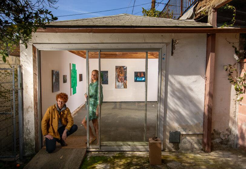 HIGHLAND PARK CA-FEBRUARY 15, 2024:Danny Bowman, left, and Alex Grunbeck are photographed at entrance to their art gallery, BOZOMAG, a converted garage located at their home in Highland Park. The current exhibition is called, "Nouveau Bozeaux." (Mel Melcon / Los Angeles Times)