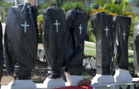 Black plastic bags with taped crosses cover stone letters of the name Brumadinho, after a dam owned by Brazilian mining company Vale SA collapsed, in Brumadinho, Brazil February 1, 2019. REUTERS/Washington Alves