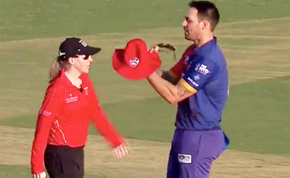 Mitchell Johnson, pictured here being escorted away by umpire Kim Cotton.