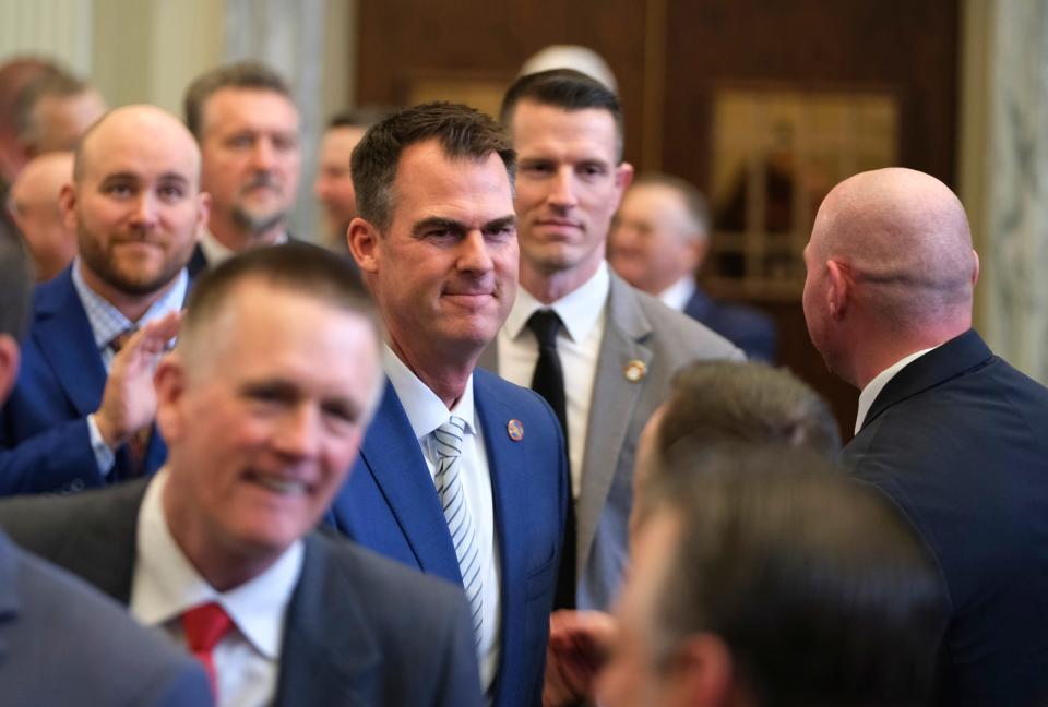 Gov. Kevin Stitt makes his way through the House floor Monday before his State of the State speech at the Capitol.
