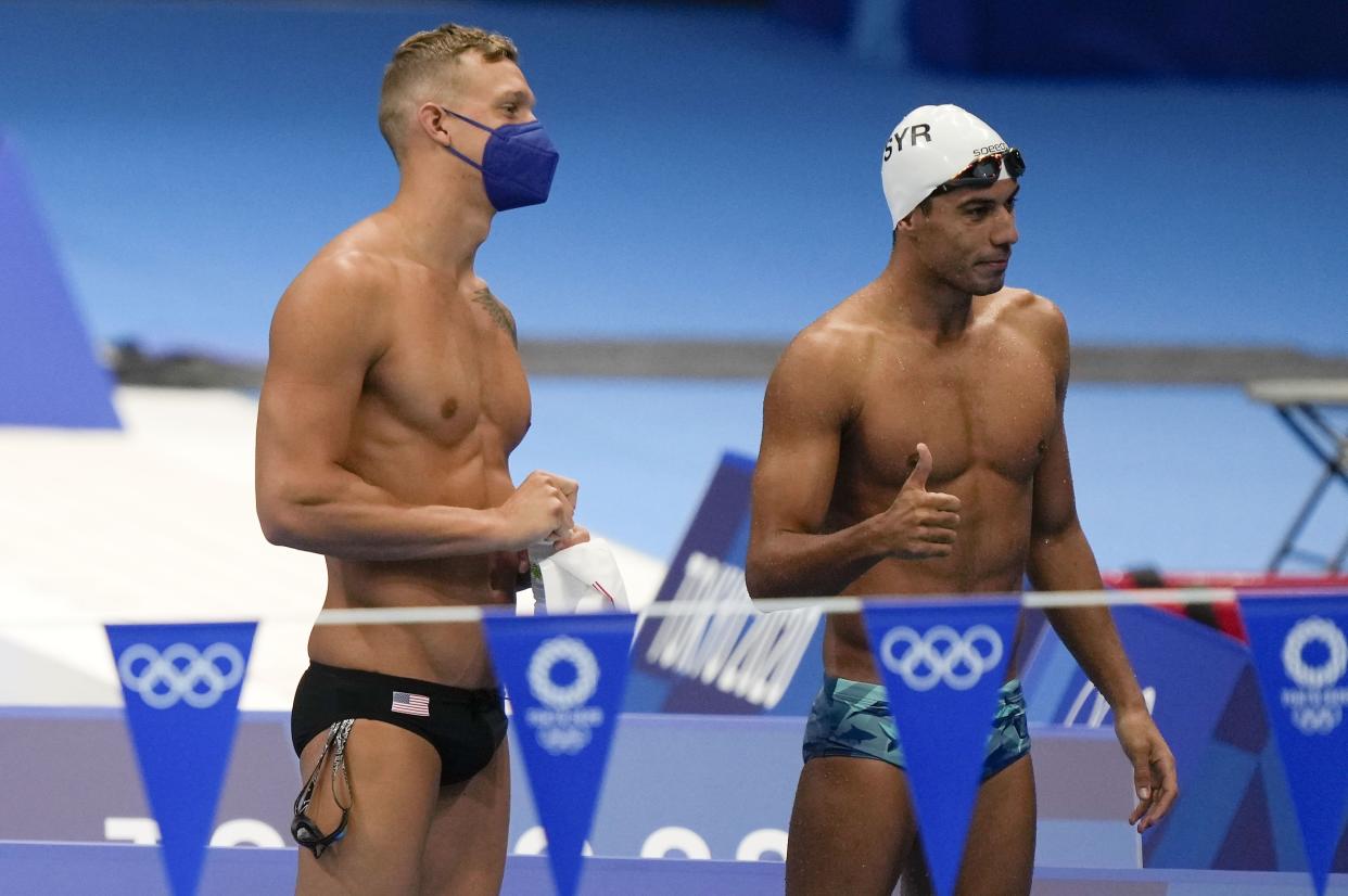 Caeleb Dressel, star swimmer of the United States, left, poses for a private photo with Syrian swimmer Alaa Maso of the IOC Refugee Olympic team, right, at the pool during a swimming training session at the Tokyo Aquatics Centre at the 2020 Summer Olympics, Thursday, July 22, in Tokyo. 