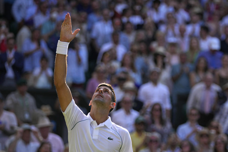 Serbia's Novak Djokovic celebrates after beating Britain's Cameron Norrie in a men's singles semifinal on day twelve of the Wimbledon tennis championships in London, Friday, July 8, 2022. (AP Photo/Alastair Grant)