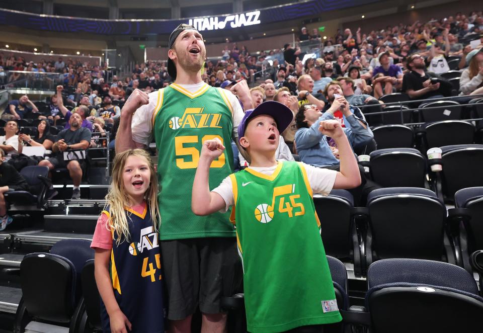 James Terry and his children Bradley and Braelynn watch the Utah Jazz make their 16th pick for Keyonte George during a draft fan event in Salt Lake City on Thursday, June 22, 2023 during the NBA draft. | Jeffrey D. Allred, Deseret News