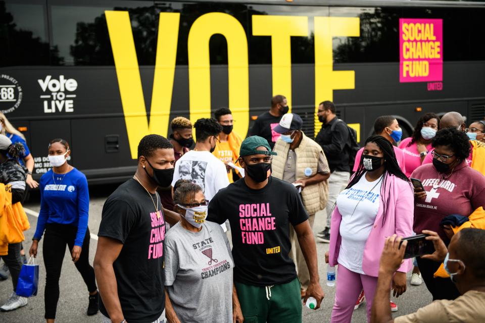 NBA players Dennis Smith Jr. and Chris Paul stop and take pictures with fans while leading Fayetteville State students over to Smith Recreation Center to vote on Wednesday, Oct. 28, 2020. Paul is traveling the country going to historically black colleges to get people to vote in the upcoming election.