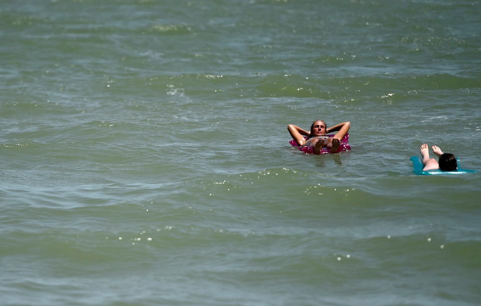 People go to the beach, Friday, July 3, 2020, at North Beach. The city of Corpus Christi closed vehicle access to parks and beaches Friday, July 3 to Tuesday, July 7 to prohibit crowding for the Fourth of July weekend.