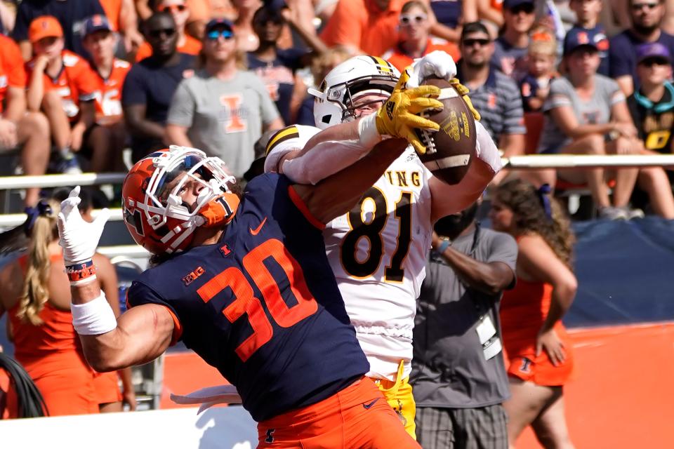 Illinois defensive back Sydney Brown (30) breaks up a pass intended for Wyoming tight end Treyton Welch in the end zone during an NCAA college football game, Sunday, Aug. 28, 2022, in Champaign, Ill. (AP Photo/Charles Rex Arbogast)