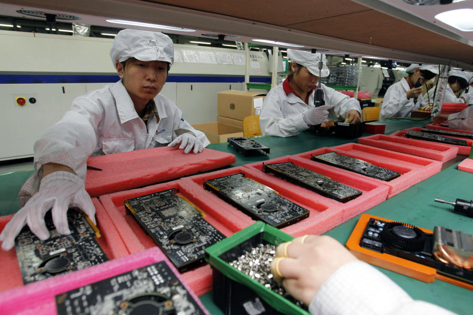 FILE - In this May 26, 2010 file photo, staff members work on the production line at the Foxconn complex in the southern Chinese city of Shenzhen. The company that makes Apple’s iPhones suspended production at a factory in China on Monday, Sept. 24, 2012, after a brawl by as many as 2,000 employees at a dormitory injured 40 people. The fight, the cause of which was under investigation, erupted Sunday night at a privately managed dormitory near a Foxconn Technology Group factory in the northern city of Taiyuan, the company and Chinese police said. (AP Photo/Kin Cheung, File)