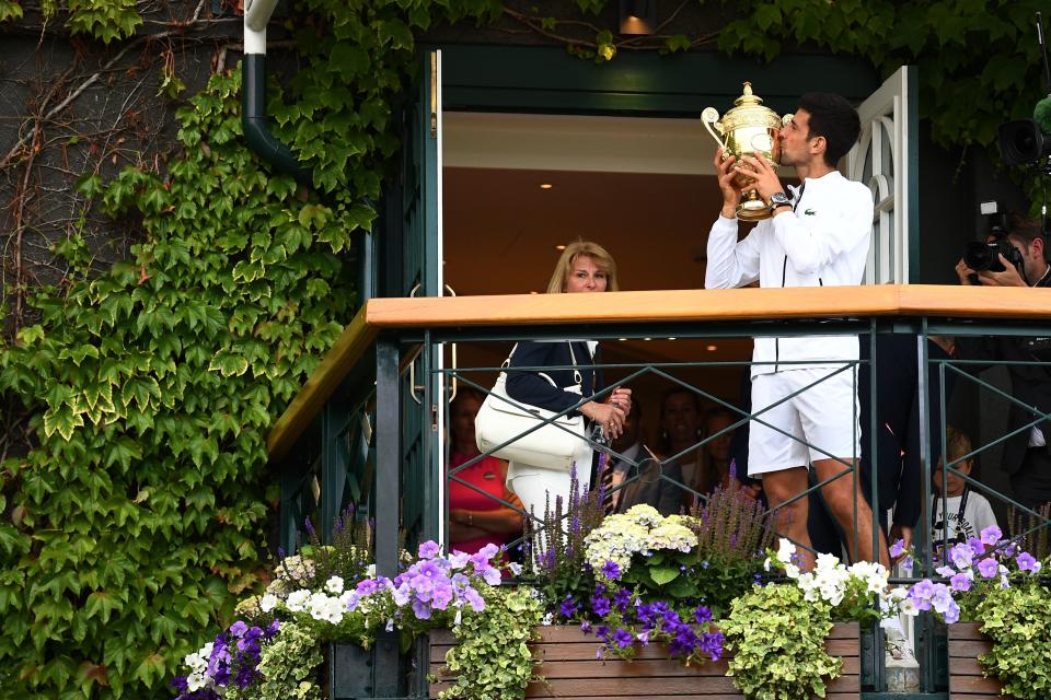 Novak Djokovic raises the trophy to the crowd. (Credit: Getty Images)