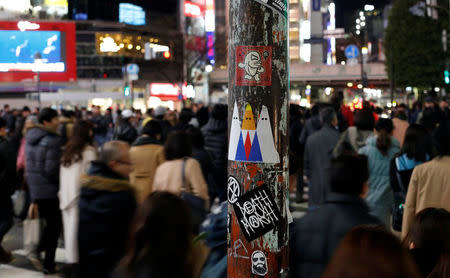 A sticker art depicting U.S. President Donald Trump, made by a Japanese graffiti artist known as 281 Antinuke, is seen at a busy crossing in Tokyo's Shibuya shopping and entertainment district, Japan, January 27, 2017. Picture taken January 27, 2017. REUTERS/Toru Hanai