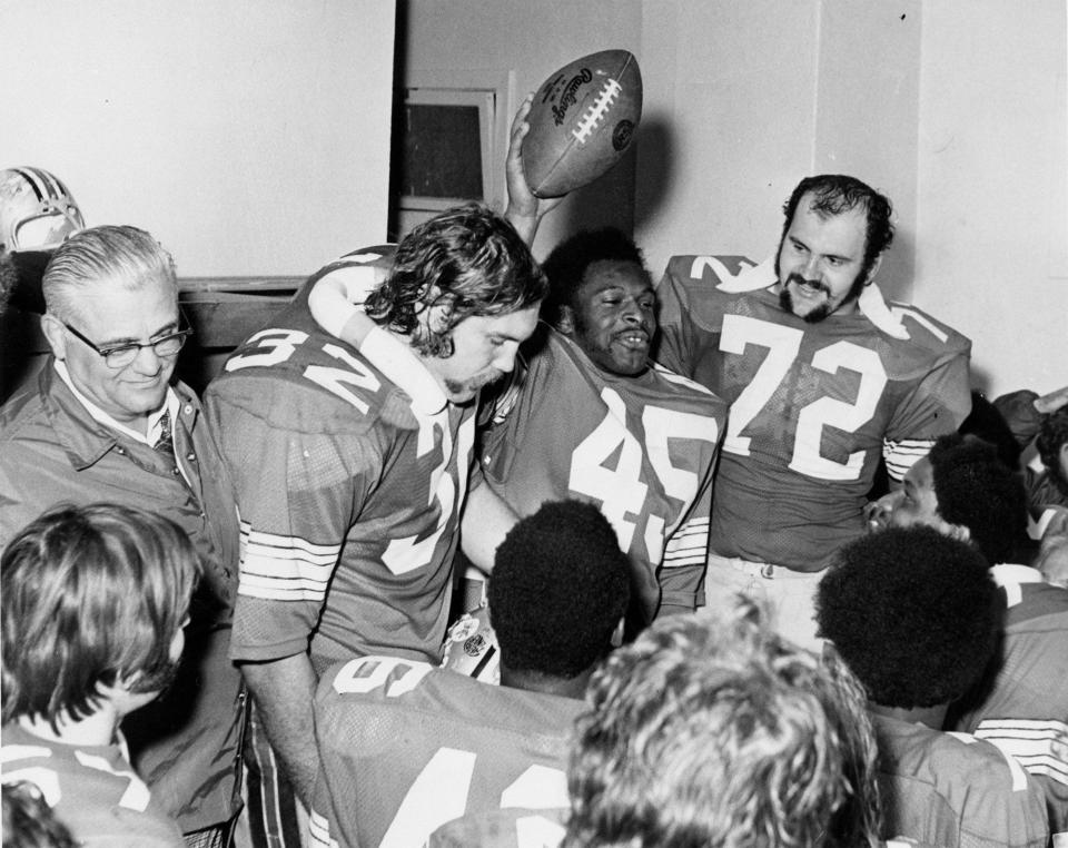 college football victory - GRIFFIN'S TROPHY -- All-American Archie Griffin , whose 45-yard final period touchdown run closed out Ohio State's scoring in the 42-21 Rose Bowl victory in 1974 against the USC Trojans, holds the game ball he was presented in the dressing room. Coach Woody Hayes is at left. Other Ohio State players are Rick Middleton (32) and Kurt Schumacher (72).

Columbus Dispatch file photo