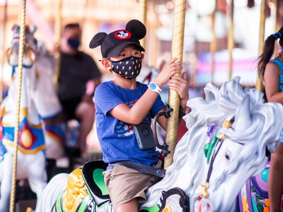 A young Disney fan wears a hat with Mickey ears at Disney World on Aug 12, 2020.