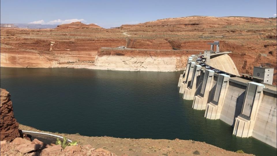 This Aug. 21, 2019 image shows Glen Canyon Dam in Page, Arizona. Environmental groups that have long pushed to bring down the dam along the Colorado River filed a lawsuit Tuesday, Oct. 2, 2019. They allege the U.S. Bureau of Reclamation ignored climate science when approving a 20-year operating plan for the dam. (AP Photo/Susan Montoya Bryan)