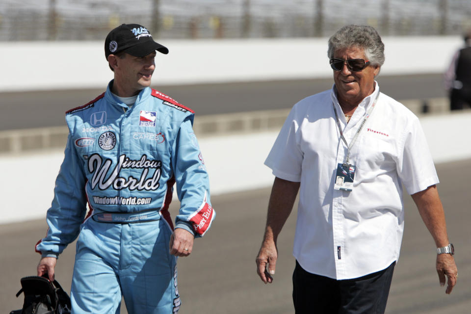 FILE - In this May 10, 2009, file photo, John Andretti, left, walks out of the pit area his his uncle, Mario Andretti, after a practice session on the second day of qualifications for the Indianapolis 500 auto race at the Indianapolis Motor Speedway in Indianapolis. John Andretti, a member of one of racing's most families, has died following a battle with colon cancer, Andretti Autosports announced Wednesday, Jan. 30, 2020. He was 56. (AP Photo/Darron Cummings, File)