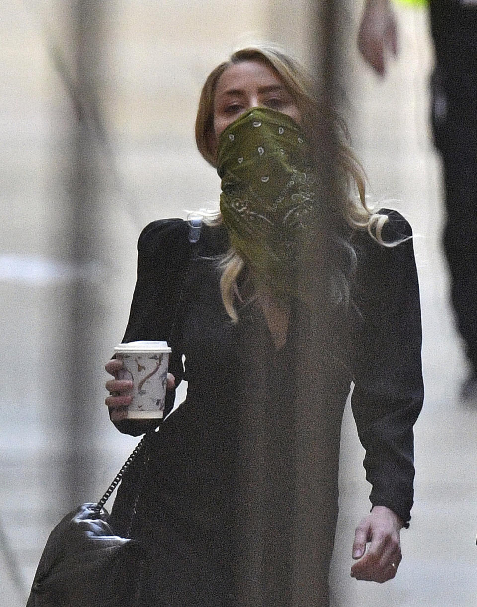 Actress Amber Heard arrives at the High Court in London for a hearing in Johnny Depp's libel case, Friday July 10, 2020. Depp is back in the witness box at the trial of his libel suit against a tabloid newspaper that called him a "wife-beater" in an April 2018 article that said he'd physically abused ex-wife Amber Heard. Depp strongly denies the allegations. (Victoria Jones/PA via AP)