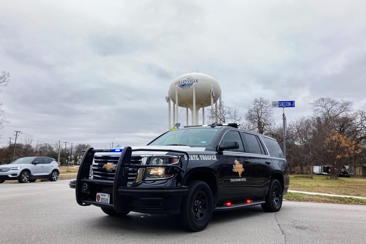 A Texas state trooper blocks traffic on a road leading to a Colleyville, Texas synagogue where a man apparently took hostages on Saturday, Jan. 15, 2022.