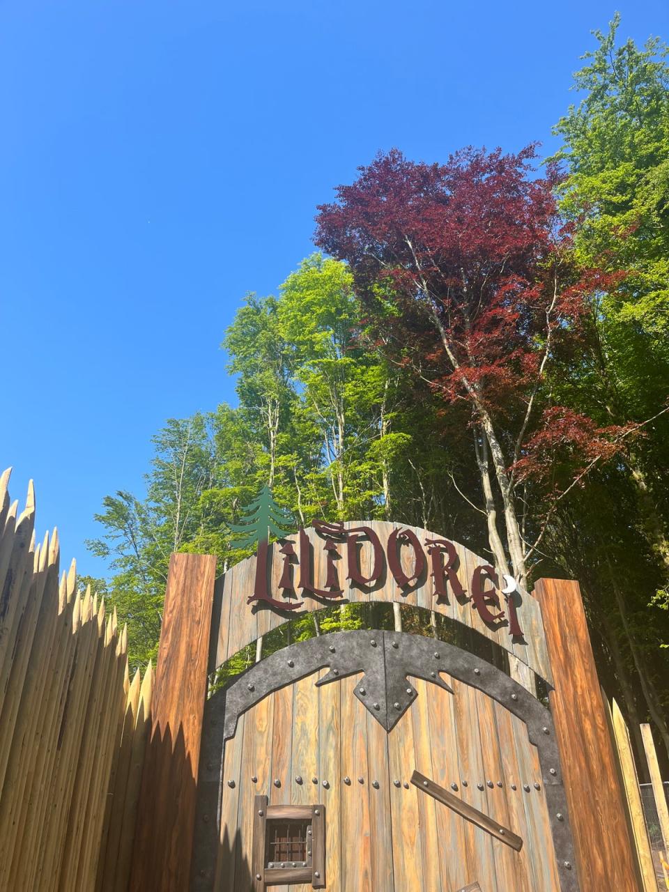 A medieval-style gate signals the start of the play village at Lilidorei (Helen Wilson-Beevers for The Independent)