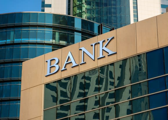 A building with reflective surface and the word bank at the top.