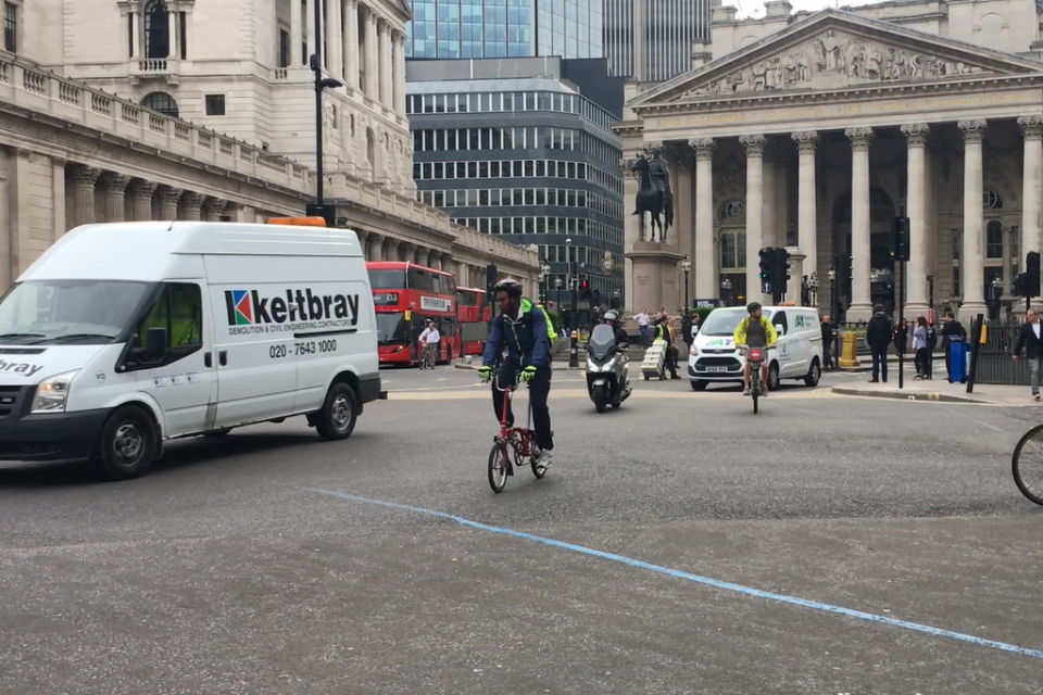 Vans cross the junction alongside cyclists this morning