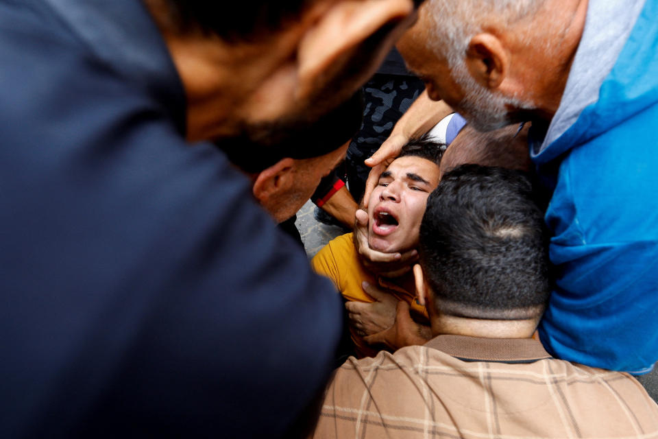 A person is pulled alive from the rubble of a house destroyed in Israeli strikes in the southern Gaza Strip on Monday. (Ibraheem Abu Mustafa/Reuters)