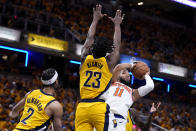 New York Knicks guard Jalen Brunson (11) shoots over Indiana Pacers guard Andrew Nembhard (2) and forward Aaron Nesmith (23) during the first half of Game 3 in an NBA basketball second-round playoff series, Friday, May 10, 2024, in Indianapolis. (AP Photo/Michael Conroy)